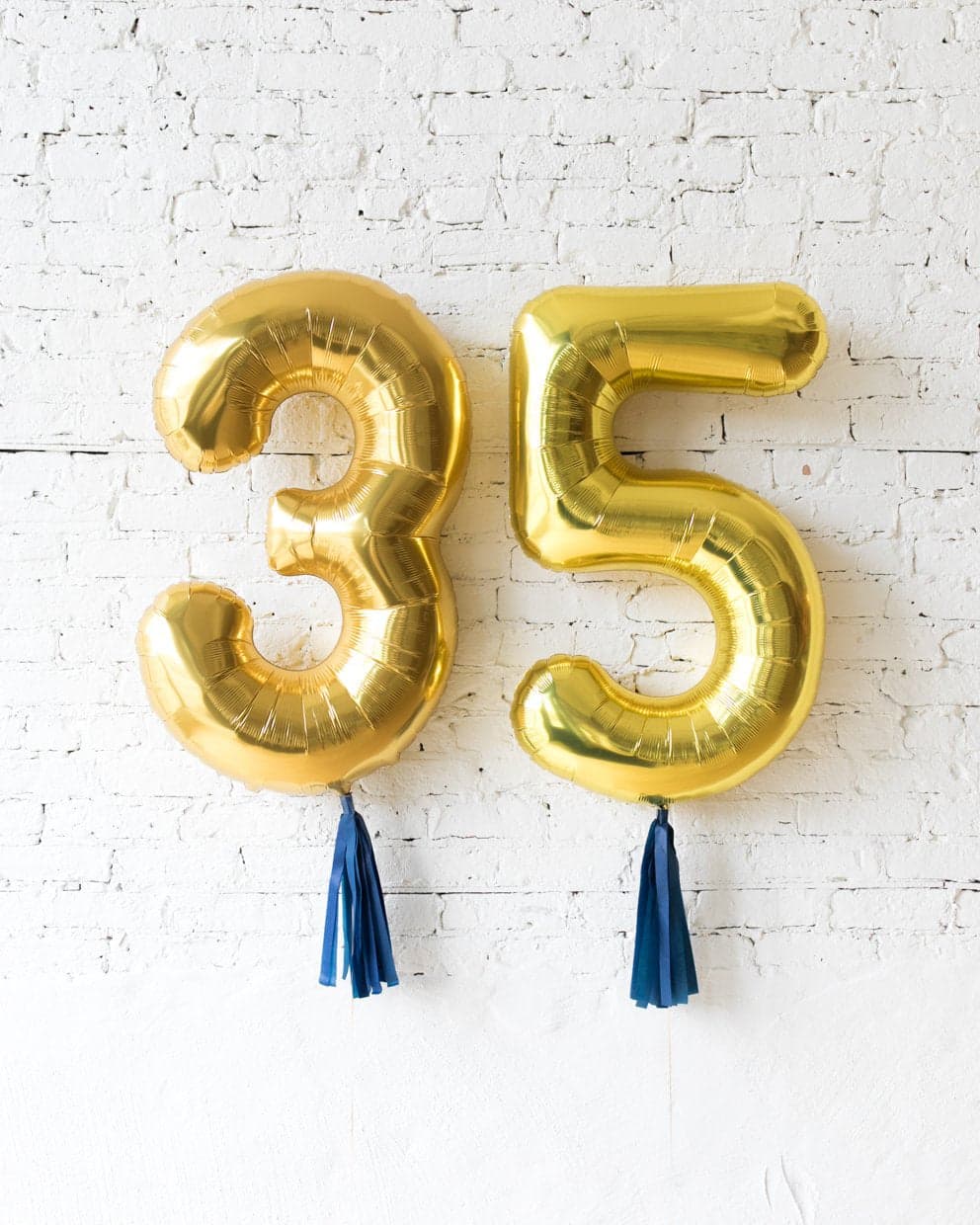 34in Gold Foil Numbers with Navy skirt | Rental